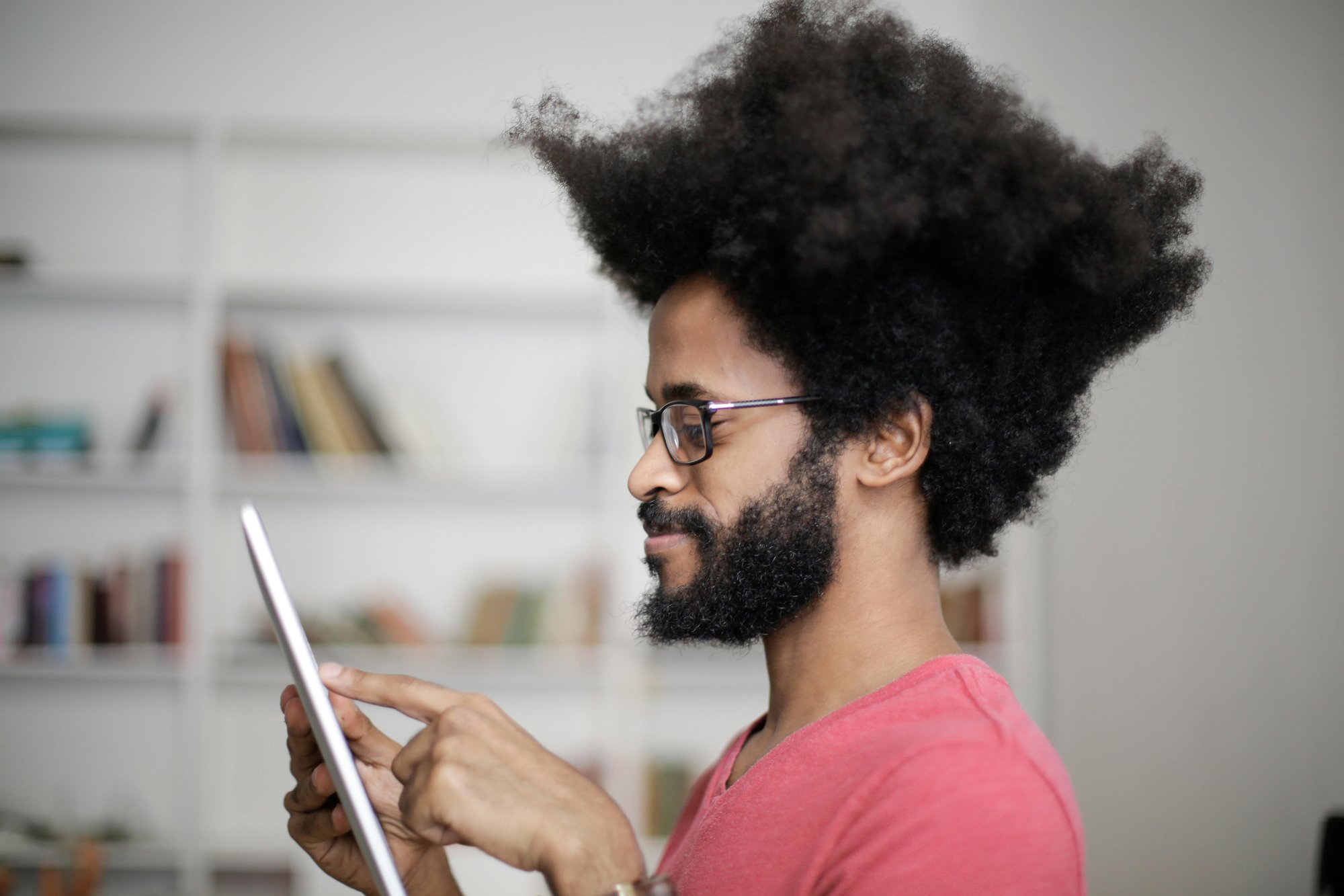 man with big hair reading ipad